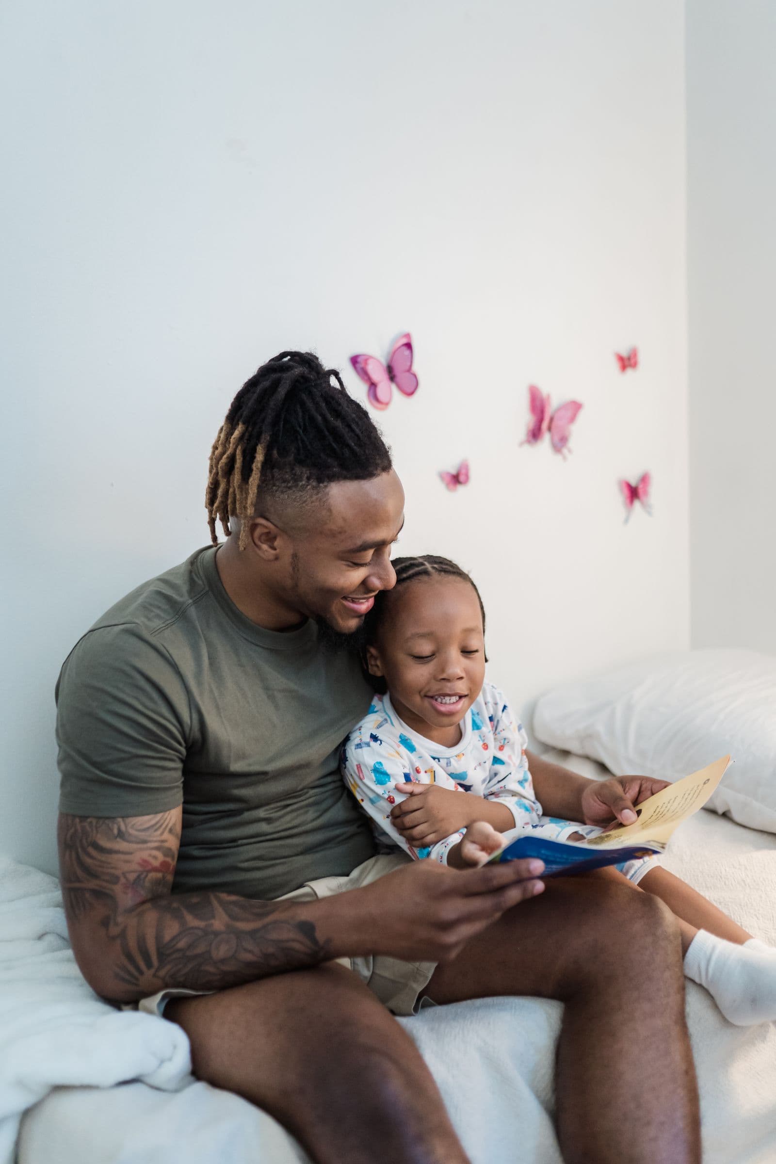 A father reading a book with his young daughter